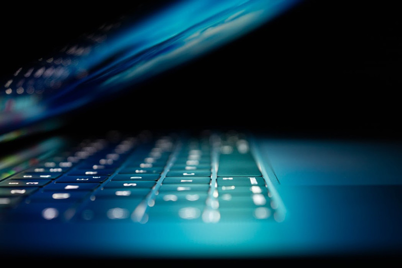 Close-up of a laptop’s screen glowing over the keyboard