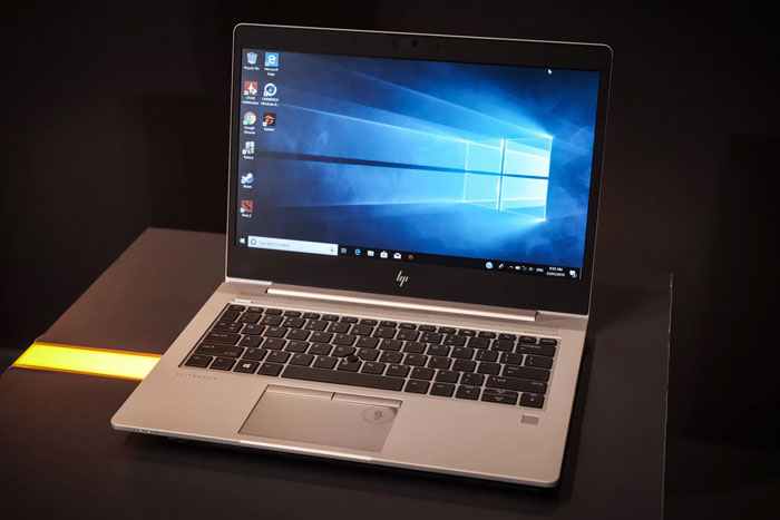 an HP laptop sits on a desk