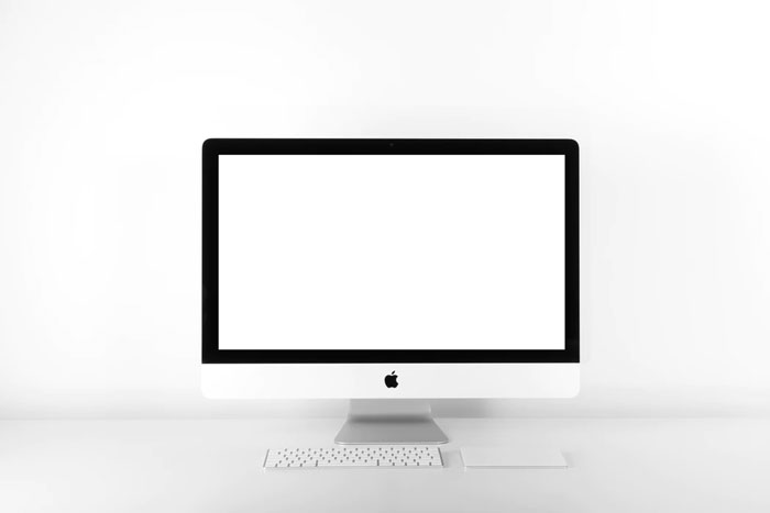an iMac sits on a desk